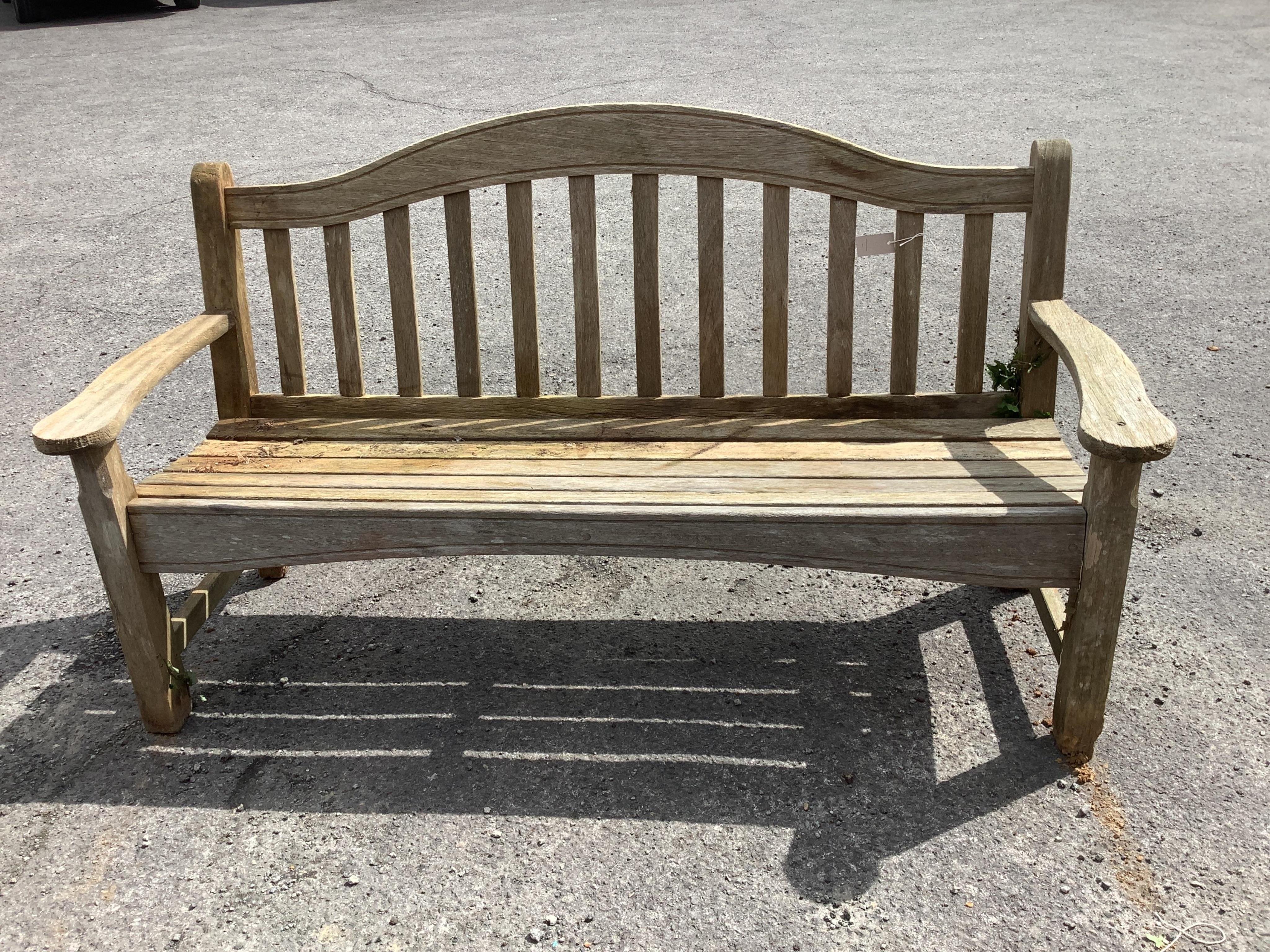 A weathered teak garden bench, width 161cm, height 90cm